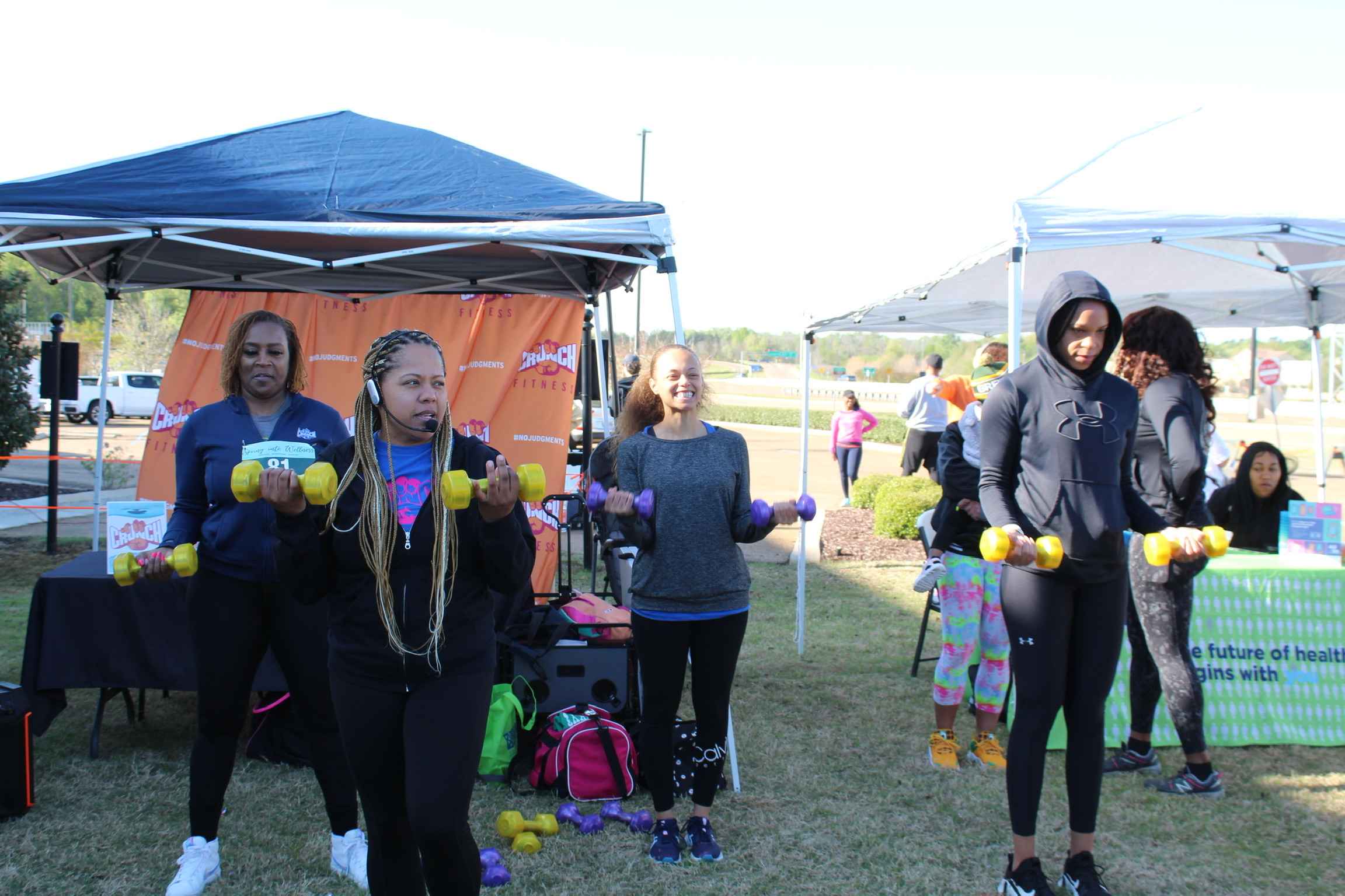 Crunch Fitness instructor Shannon Jones leads a warmup exercise.